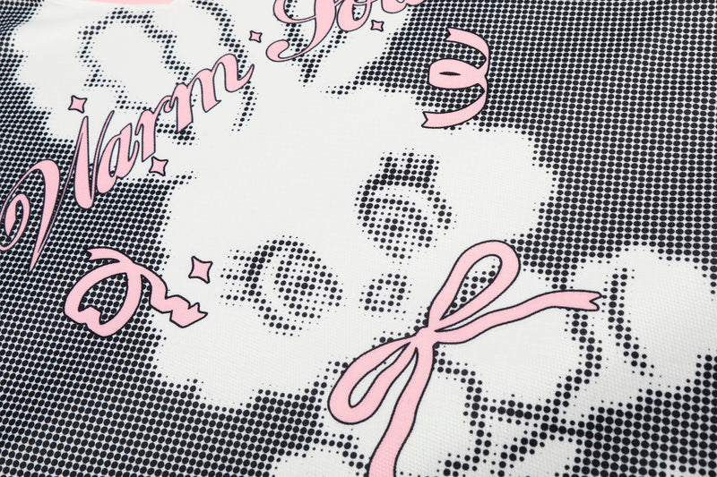 Close-up of black and white mesh jersey with pink Warm Love bunny graphic and playful streetwear lettering