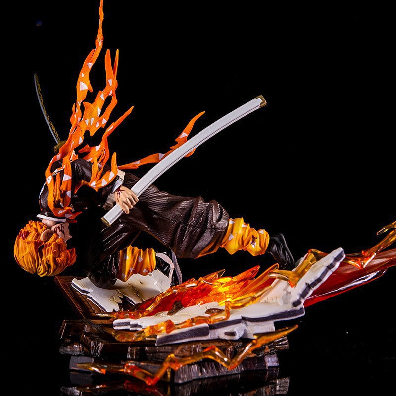 The Demon Slayer: Rengoku Kyojuro Flame Hashira figure, crafted from high-quality PVC and standing 28cm tall, showcases striking orange flames as he wields his sword mid-attack against a reflective black background.