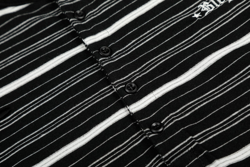 Close-up of front buttons and striped fabric on black Henley long sleeve tee