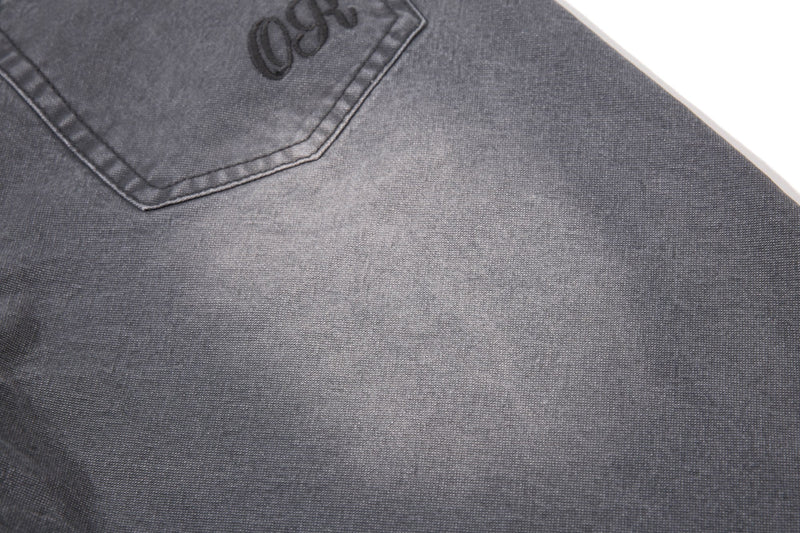 Close-up of charcoal denim back pocket with logo embroidery