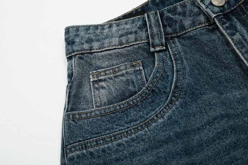 Close-up of back pocket and belt loop on blue wash denim shorts