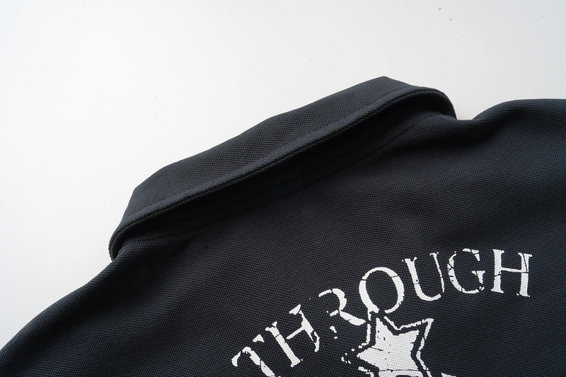 Black polo collar and upper chest close-up with distressed white graphic print