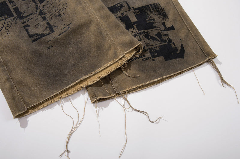 Close-up of frayed hem on olive brown graphic cargo shorts