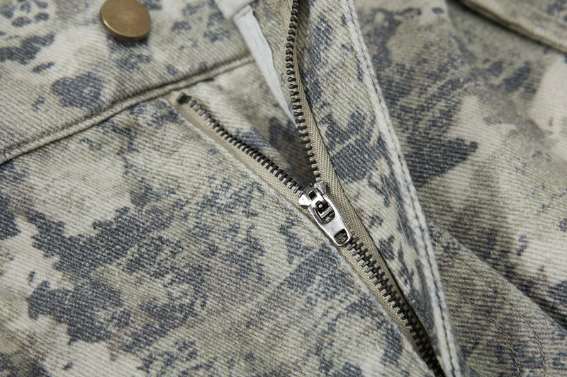 Close-up of front seam and zipper pocket on camouflage cargo pants