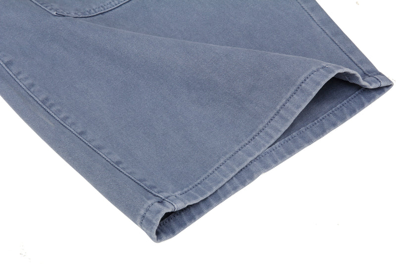 Close-up of the hem on blue wide leg jeans