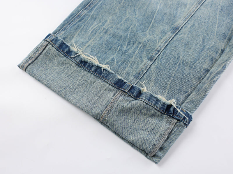 Close-up of the frayed hem on light wash wide-leg denim pants