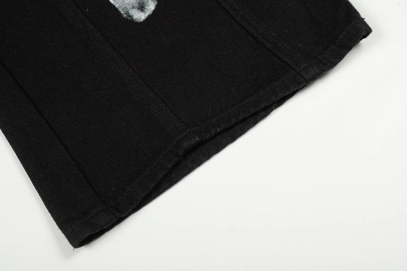 Close-up of hem on black denim wide-leg jeans