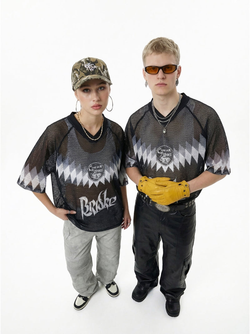 Black mesh streetwear soccer jersey with jagged graphic print, worn by two models on a white background