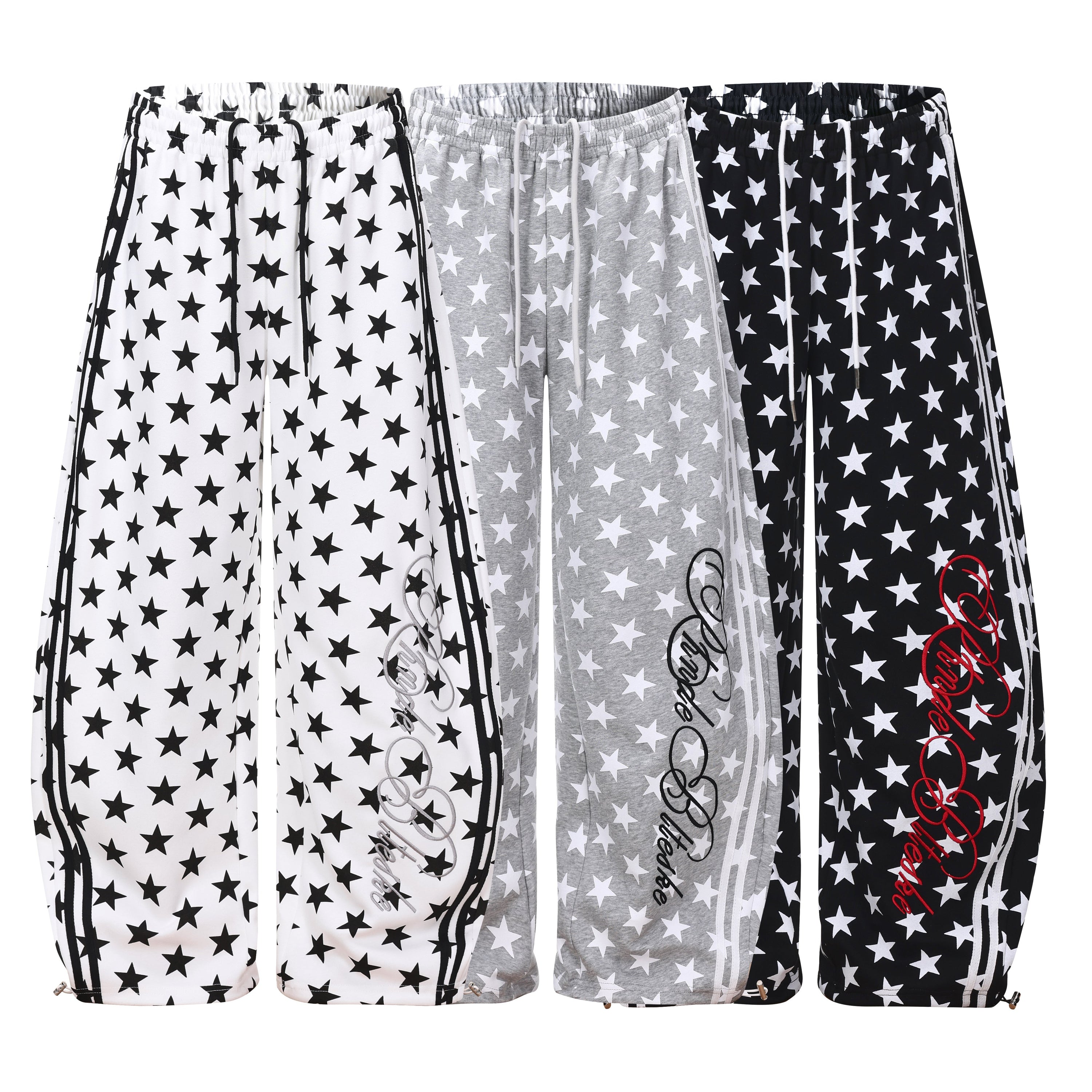 White wide-leg sweatpants with all-over black star print, side stripe panels, and script logo graphic on the leg