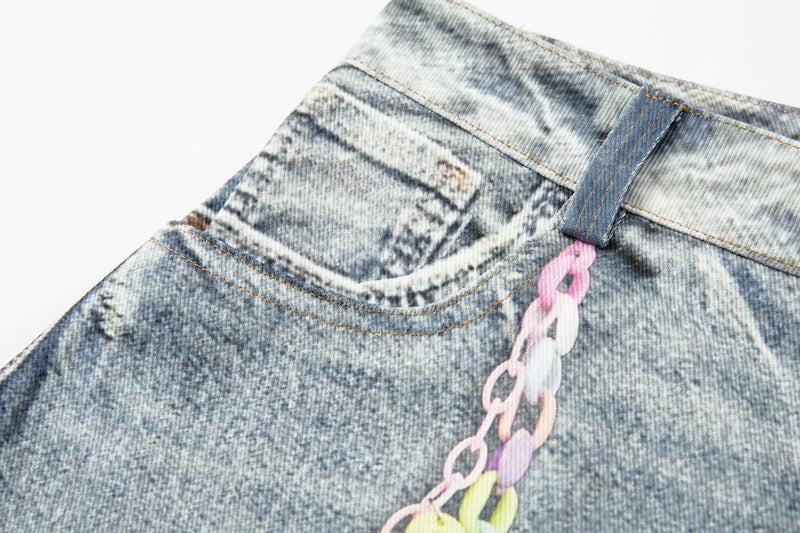 Close-up of left waistband and pink chain trim on acid wash denim shorts