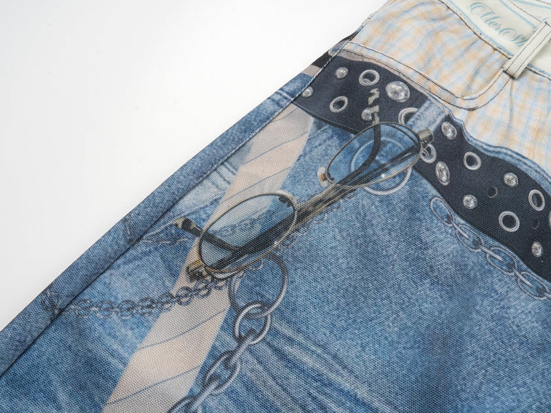 Side close-up of denim print pants with printed chain and eyeglasses graphic