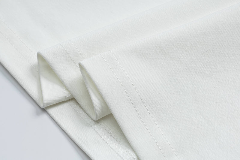 Folded white vintage football jersey tee with textured fabric and visible stitched hems