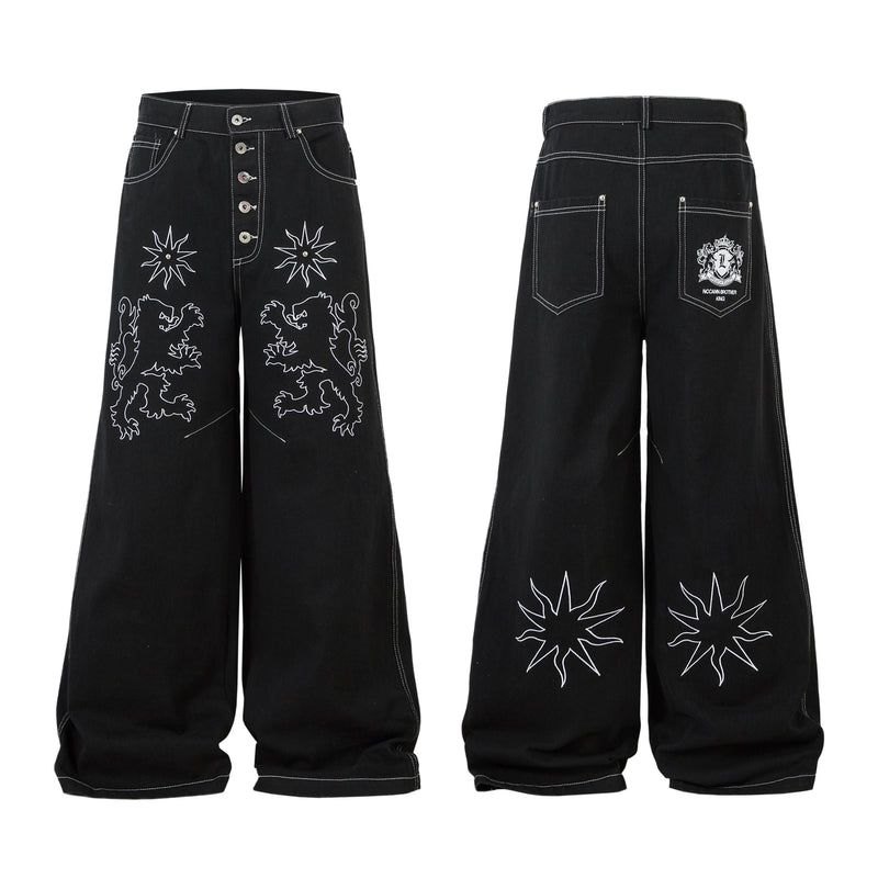Black wide-leg jeans with white heraldic lion and star outline embroidery on the front legs, shown front and back