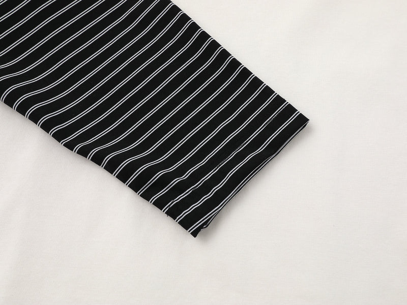 Close-up of black striped sleeve cuff on the layered long-sleeve tee
