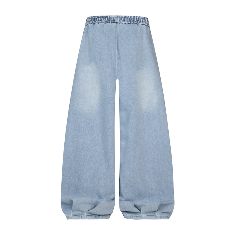 Light wash denim balloon pants with oversized wide legs and elastic waist, front view
