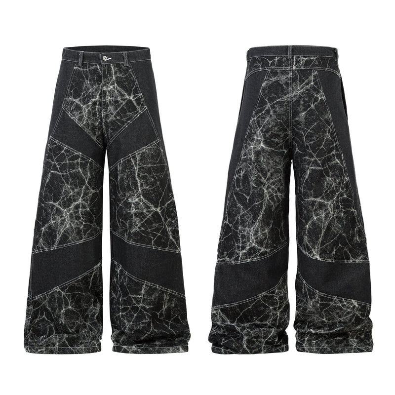 Front and back view of black wide-leg jeans with white crackle-effect wash and diagonal patchwork panel stitching