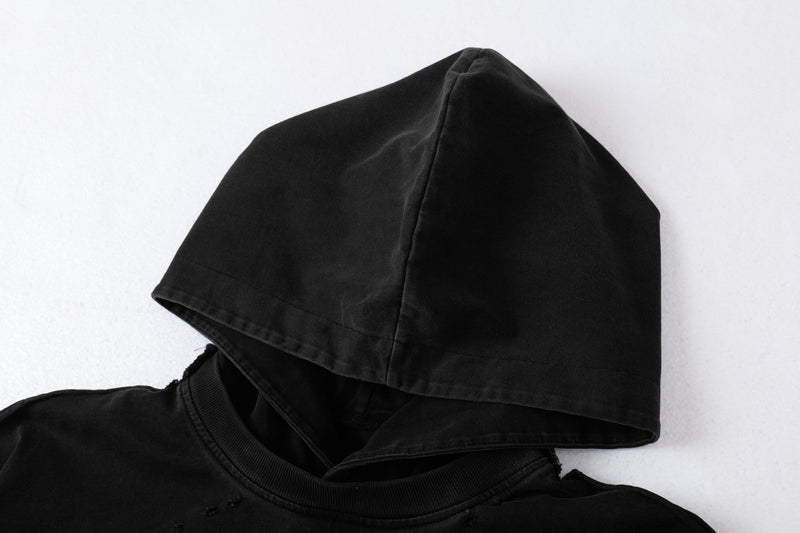Close-up of black hoodie tee hood with layered collar detail