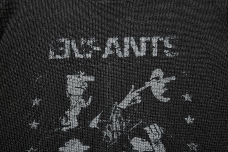 Close-up of a black waffle knit graphic T-shirt with distressed white Enfants Riches Déprimés print and star details