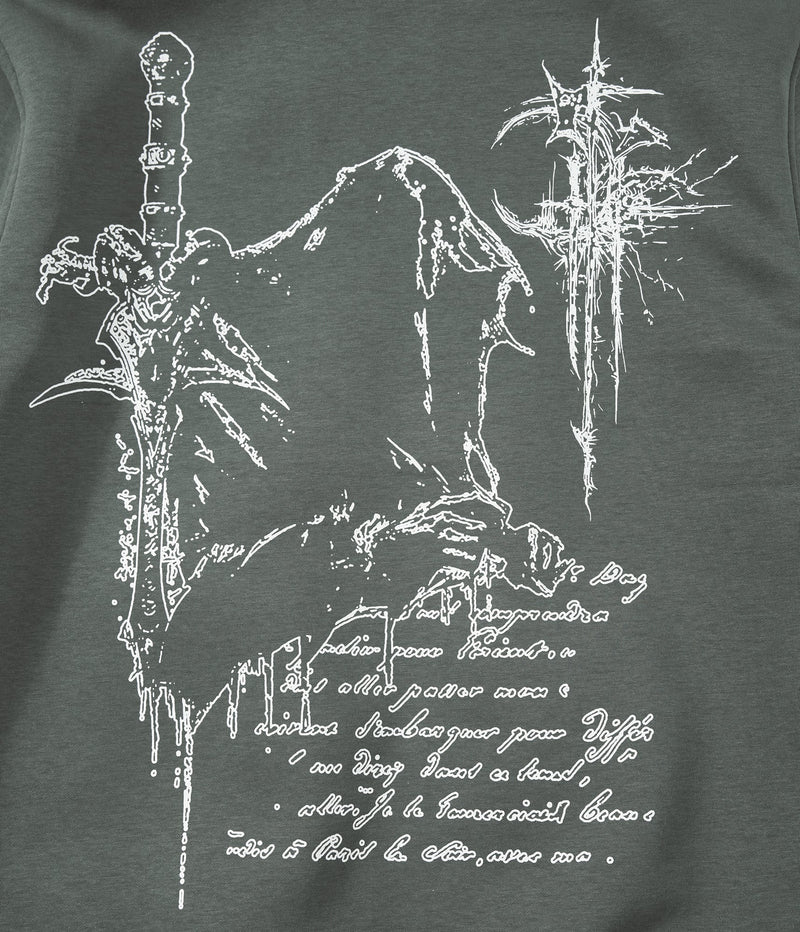 Close-up of back graphic print on dark green hoodie