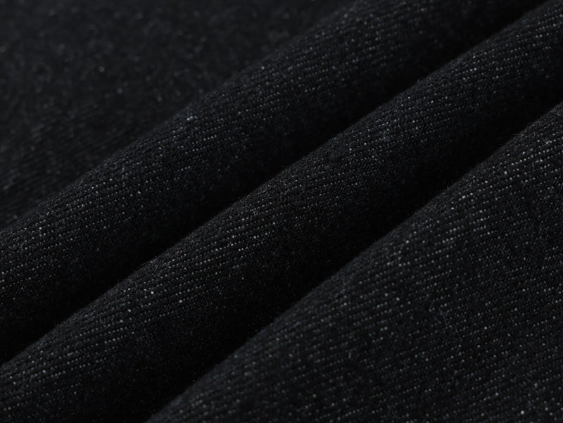 Close-up of black denim fabric texture with subtle weave detail
