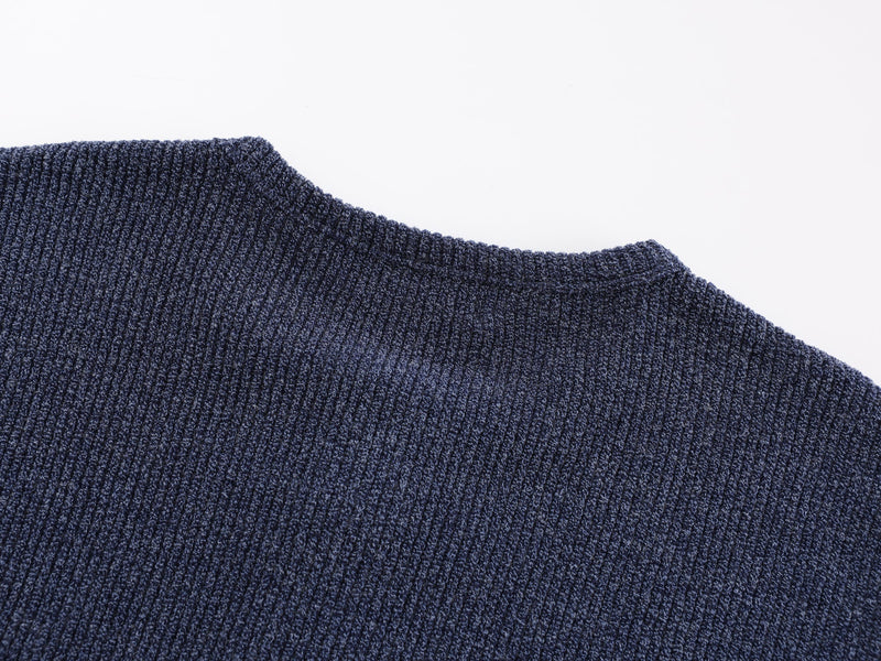 Close-up of navy ribbed knit collar and shoulder seam