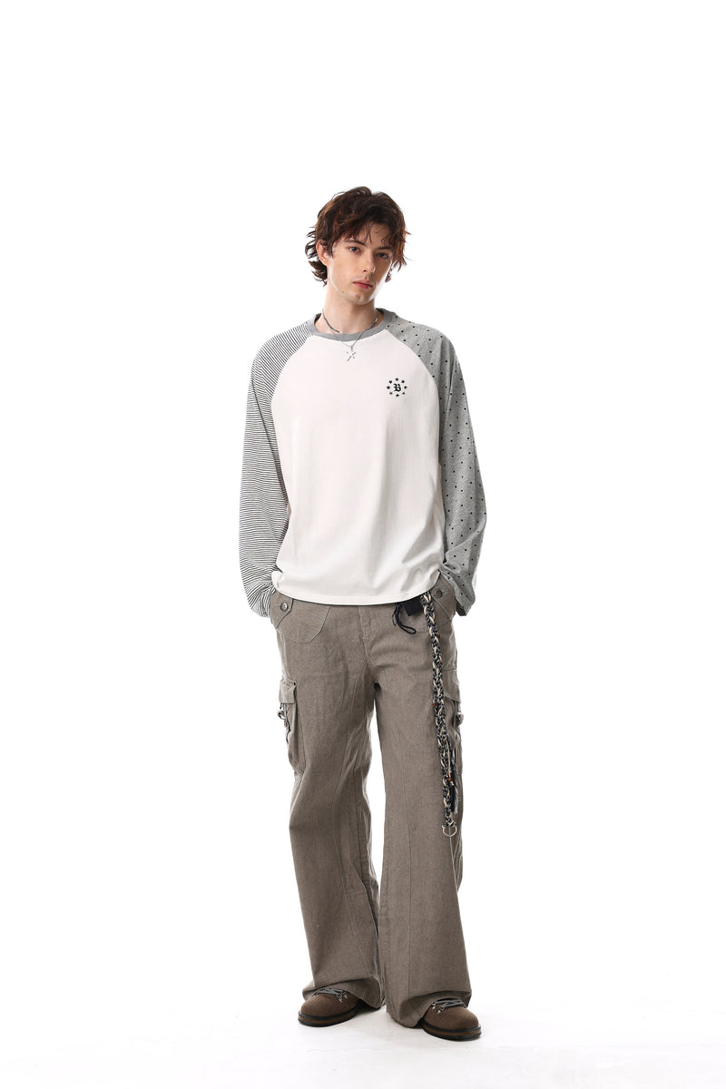 Full-length model view of white raglan tee with striped and polka dot sleeves