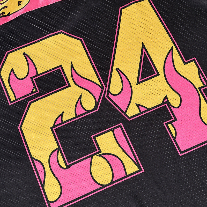 Close-up of a black mesh football jersey with neon pink and yellow flame-print lettering and bold athletic styling