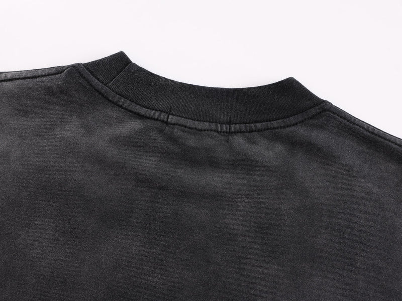Close-up of black ribbed crew neckline on long-sleeve tee