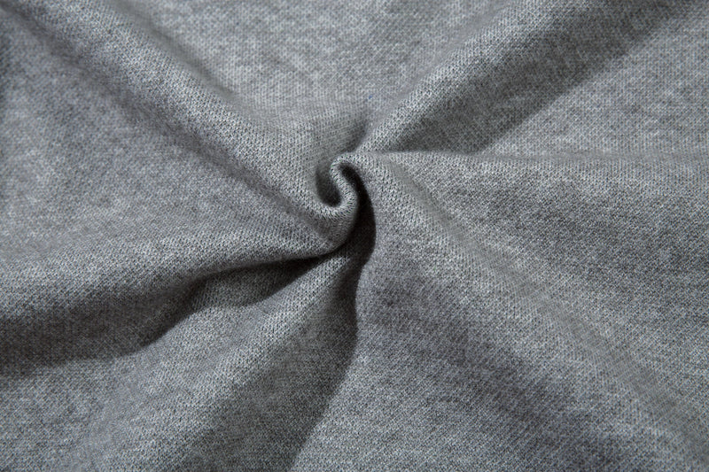 Close-up of soft gray knit fabric gathered in a twist detail