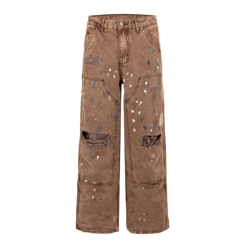 Front view of brown distressed denim pants with paint splatter and ripped knees