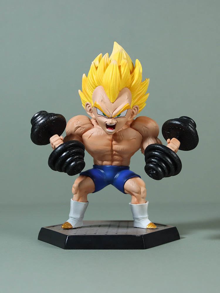 The Seakoff Vegeta Super Saiyan Collectible Figure features a cartoonish Vegeta in a weightlifting pose on a hexagonal base, with spiky yellow hair, bare chest, blue shorts, and small dumbbells. Its intense facial details and white boots capture the essence of Dragon Ball Z against a light gray-green backdrop.