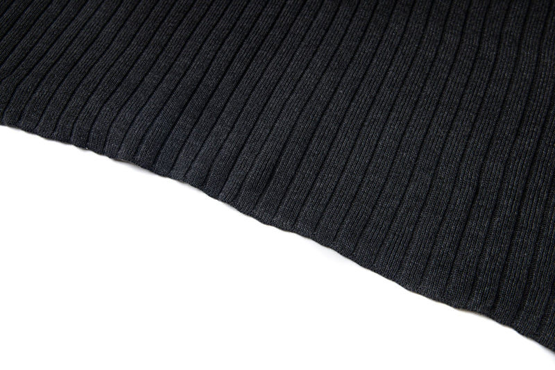 Close-up of black ribbed knit hem with straight finished edge