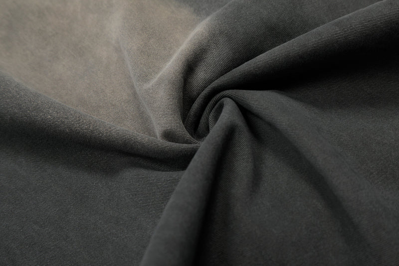 Close-up of dark charcoal washed fabric with soft faded texture
