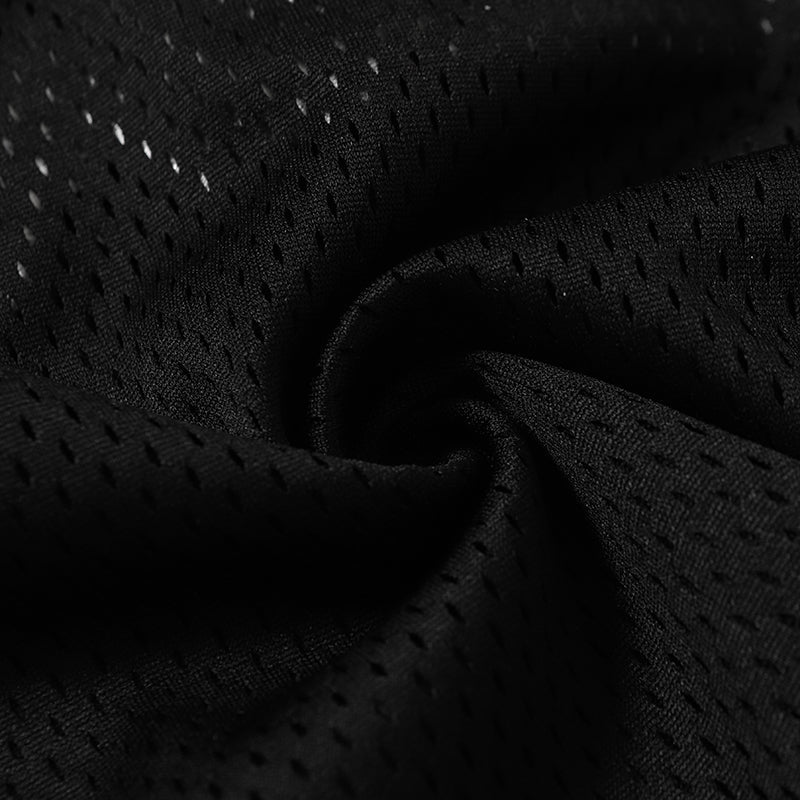 Close-up of black breathable mesh fabric with perforated texture for a varsity football jersey and streetwear tee