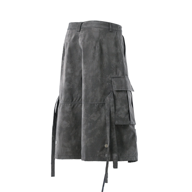 Back view of black mesh cargo shorts with snap buttons and side cargo pockets