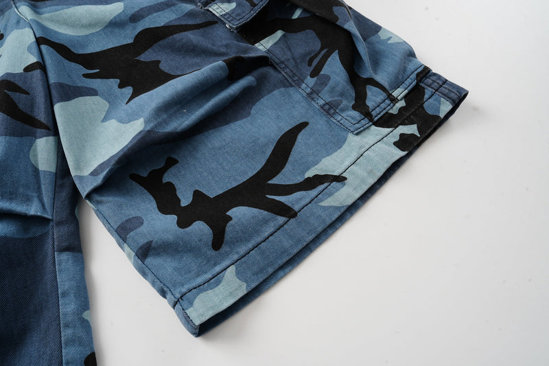 Rolled hem and side cargo pocket on blue camouflage shorts
