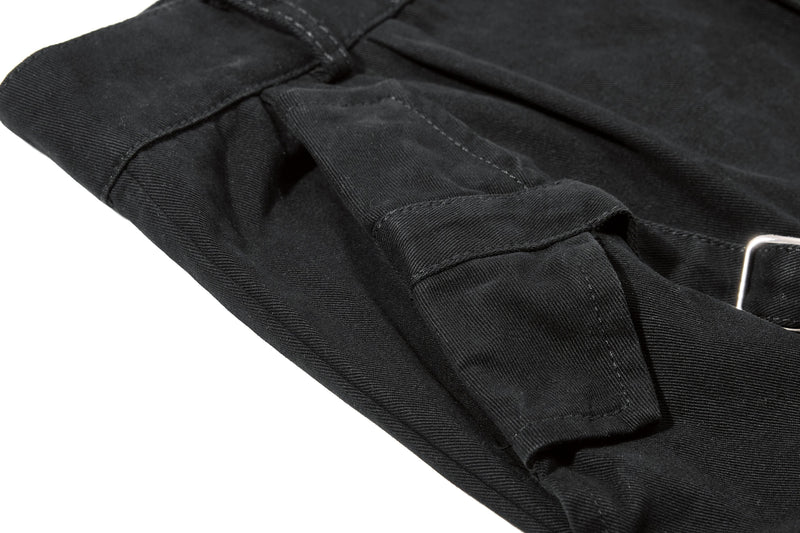 Black shorts cargo pocket flap and side seam detail, close-up