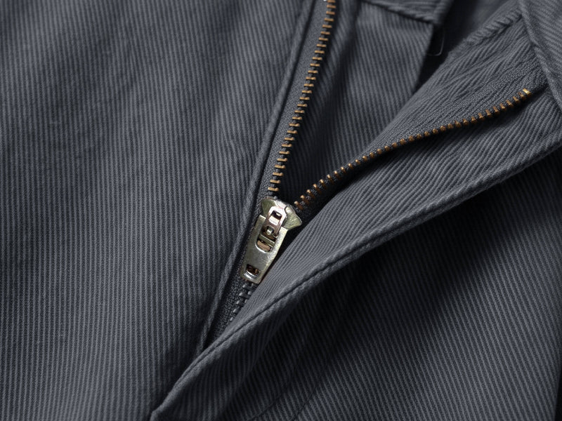 Close-up of charcoal shorts front pleats and zipper fly