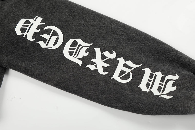 Close-up of white sleeve print on black hoodie reading MaxDepy