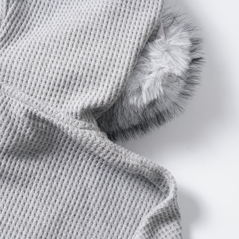 Close-up side view of the hood edge with white and gray faux fur trim