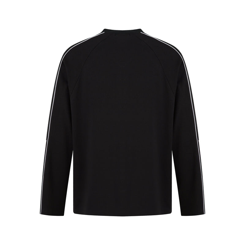 Black long-sleeve raglan top with contrast piping, back view