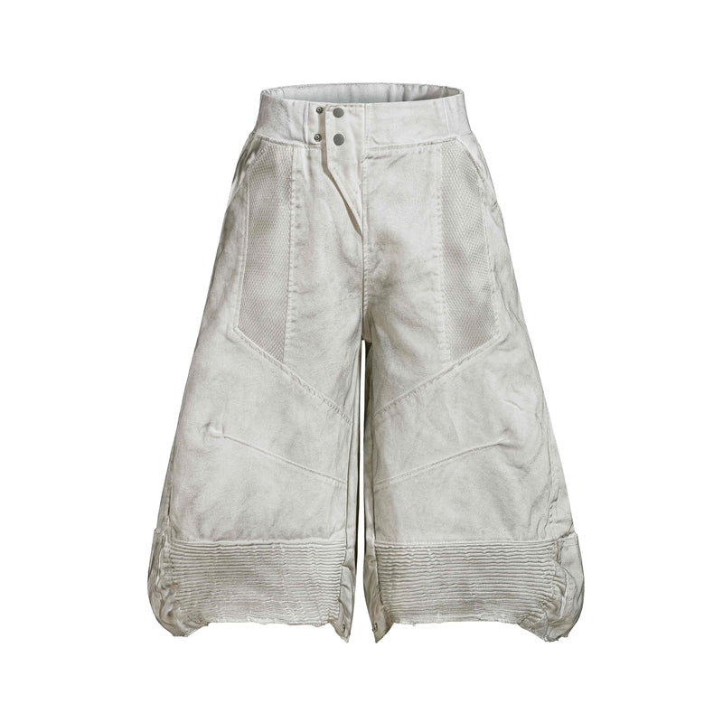 Front view of light gray oversized denim shorts with moto panel seams and wide legs