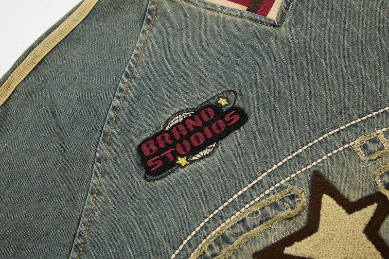 Close-up of vintage pinstripe denim tee with embroidered Brandon Studios patch and star detailing