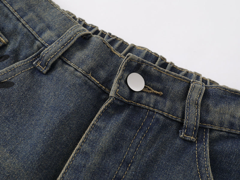 Close-up of front waistband, button closure, and belt loop on blue denim shorts