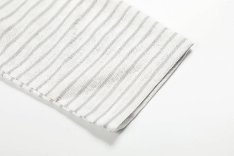Close-up of white striped sleeve hem with soft knit texture