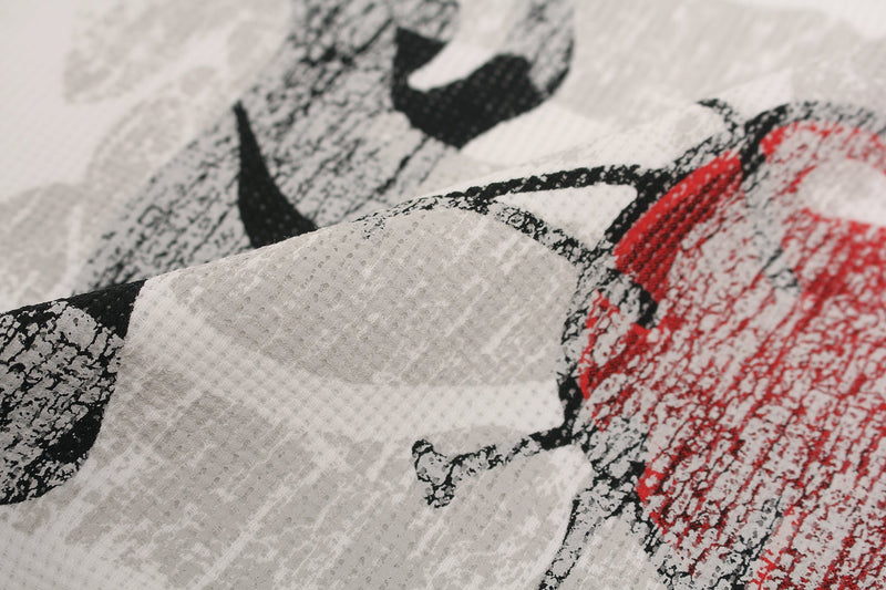 Close-up of distressed heart graphic on white streetwear tee with black and red print texture