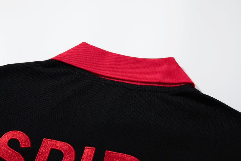 Black gothic polo tee with bold red collar and embroidered lettering, showcasing an oversized Y2K streetwear style