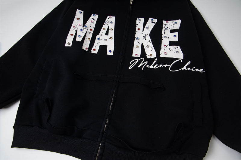 Close-up of black hoodie front with MAKE print and front pockets