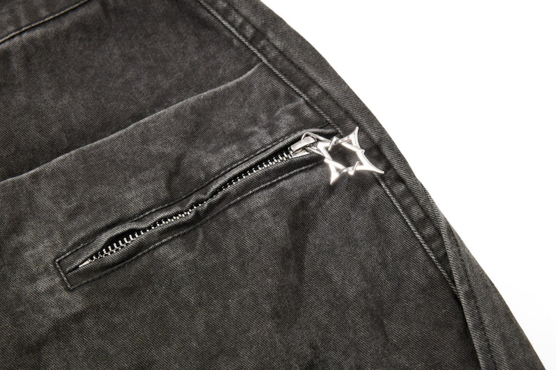 Dark charcoal denim side zipper pocket close-up with star charm