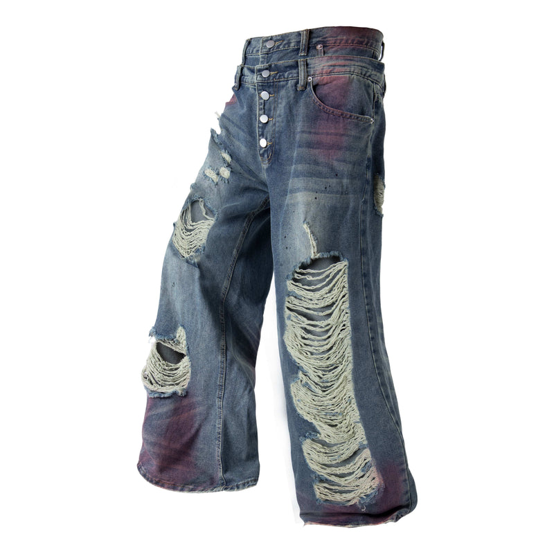 Side front view of distressed wide-leg jeans with button fly and large ripped patches on the legs